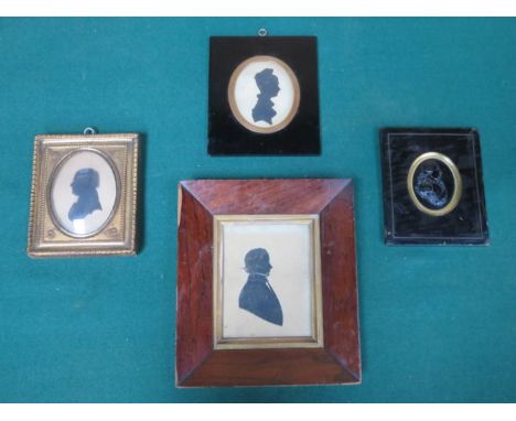 EBONISED FRAMED OVAL RELIEF DECORATED PORTRAIT AND THREE FRAMED SILHOUETTES 