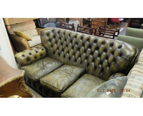 A leather upholstered sofa, deep buttoned