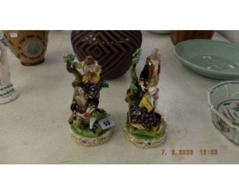 A pair of 19th century porcelain figures in 18th century costume, decorated in colour enamel and gilt, both marked Bloor Derb