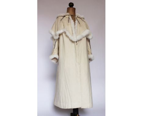 A Victorian ladies coat/cape, circa 1900, in cream with applied ribbon detail and rabbit fur trim, gathered sleeves, lined th
