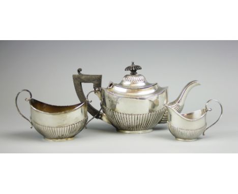 An associated three piece silver bachelors tea set,  Martin Hall & Co & Ltd, comprising; a teapot, Chester 1907, 13cm high wi