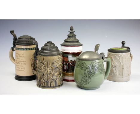 Two 19th century German steins, comprising a relief moulded faience motto example with pewter cover and mottled glazed, 6.5cm