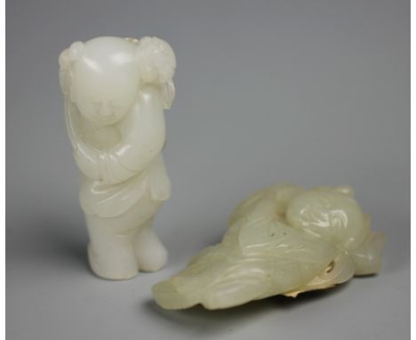 Two Chinese figural carvings, white and celadon jade, each modelled as a boy holding a lotus branch, 5.5 & 5.3cm high (2) (on