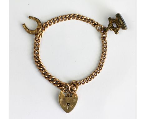 A 9ct yellow gold curb link bracelet with an attached padlock clasp, a horseshoe charm and a intaglio set gold plated fob 'Pa