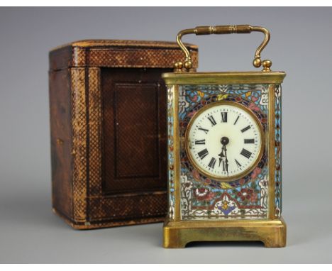 A late 19th century French brass and champleve enamel carriage time piece, with enamel Roman numeral dial and floral detailin