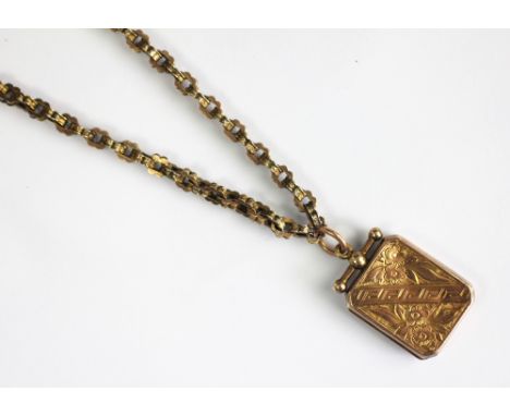 A late Victorian locket and chain, the decorative link chain with applied pad stamped '9c', and attached 9ct gold locket Birm