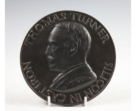 Thomas Turner (1861-1951), an 1885 commemorative cast iron plate, one side decorated with a portrait and 'Thomas Turner silic