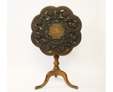 A Victorian carved oak and stained beech occasional table, the octofoil shaped top worked in high relief with flower heads an