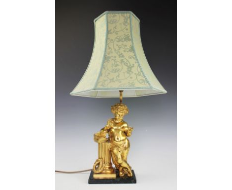 A French Empire style gilt bronze lamp, modelled as a cherub standing beside a column with books, 42cm without shade. Lightin