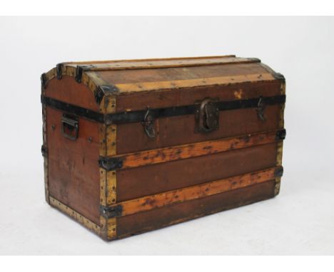 A late 19th century canvas and pine bound dome top trunk, with hinged cover revealing a vacant interior, two locking mechanis
