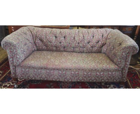 A late Victorian Chesterfield settee, with button back upholstery, on oak legs, 180cm W, with an early 20th century wing back