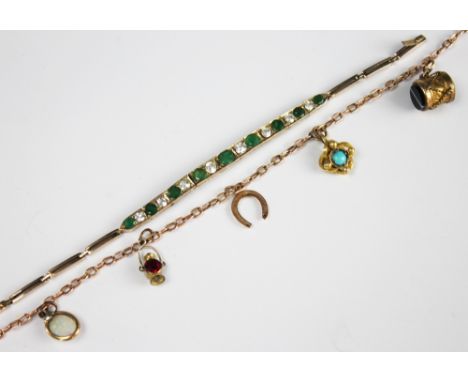 A slender 9ct gold chain bracelet hung with five attached charms, to include an opal set charm, a drum a lamp etc, unmarked, 