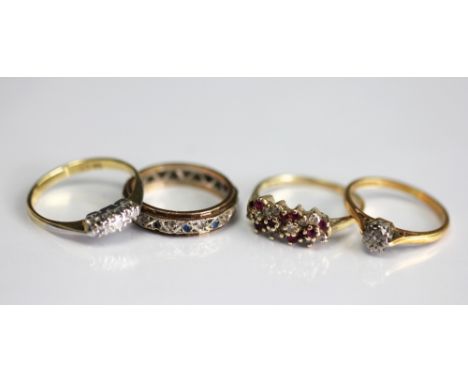 A three stone diamond ring, hoop stamped '18ct', a solitaire diamond ring in 18ct yellow gold, a ruby and diamond set ring in