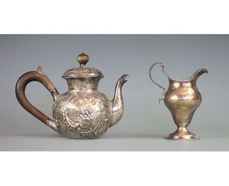 A George III silver cream jug, Ann Chesterman, London 1778, the high waisted jug upon a pedestal foot with gadrooned rims and