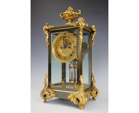 A late 19th century American gilt brass four glass mantel clock, Roman numeral chapter ring with visible escapement and eight