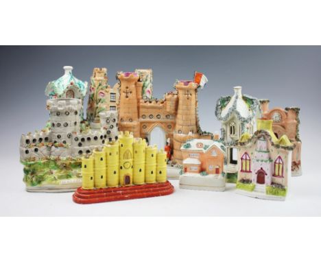 A selection of eight Victorian Staffordshire pottery castles and cottages to include; 'Sebastopol', 25cm high, 'Malakoff', 19