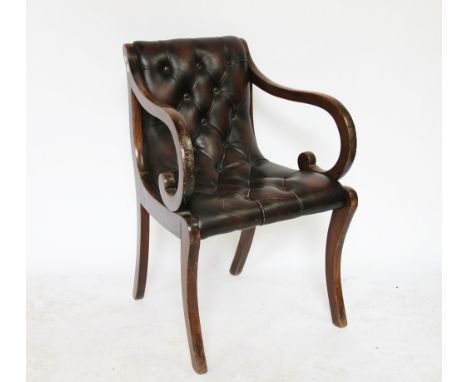 A Regency style stained beech library chair, with button leather upholstery, on sabre legs, 82cm H   CONDITION REPORT:  The s