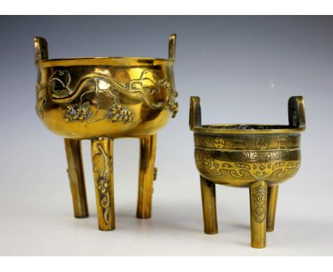 A Chinese brass tripod censer, cast with scrolling vines and squirrels in relief, 19.5cm high, along with a smaller archaic e