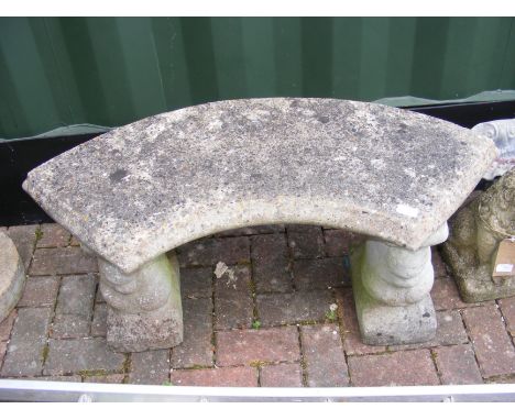 A curved concrete garden bench on squirrel formed plinths  