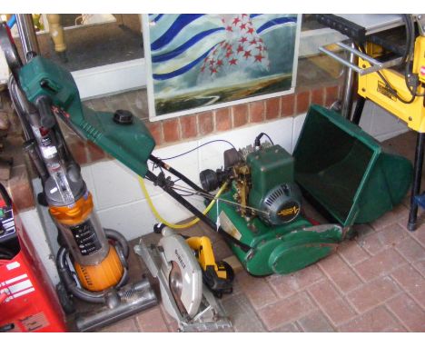 A Qualcast petrol driven mower with roller 