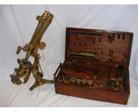 A Smith and Beck of London binocular microscope, No.1085 with original fitted mahogany carrying case with many interchangeabl