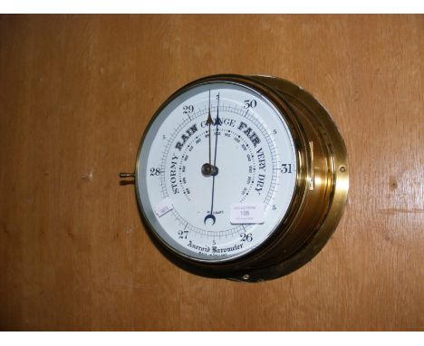 A brass cased wall aneroid barometer - 22cm diameter 