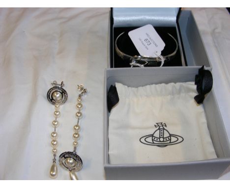 A solid silver bangle in the form of a belt, together with a pair of Vivienne Westwood costume jewellery earrings
