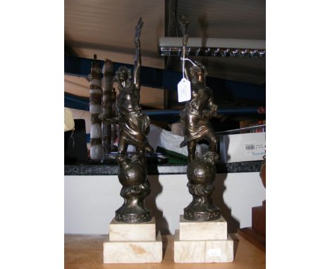 Two bronzed statues on marble plinths - in the form of robed man atop globe 