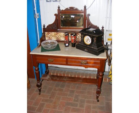 A late Victorian marble top washstand with tile and mirrored back 