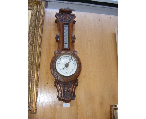 An oak case barometer/thermometer