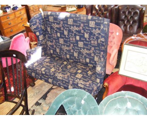 A wing back two seater sofa on claw and ball feet, upholstered in blue fabric - width 146cms CONDITION REPORT Height 126cmWid