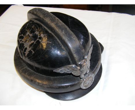 A German WWII leather NSKK motorcycle helmet, manufactured  by Becker, Berlin with silver eagle motifCONDITION REPORT.