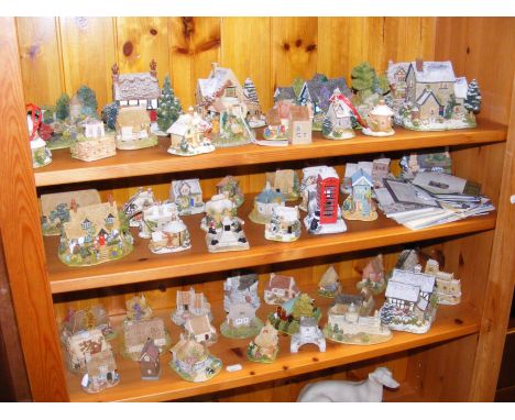 A generous quantity of Lilliput Lane model cottages - on three shelves 