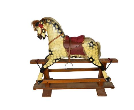 Large early 20th century painted wooden rocking horse, swinging on cruciform base, the horse approximately 110cm long, base 1