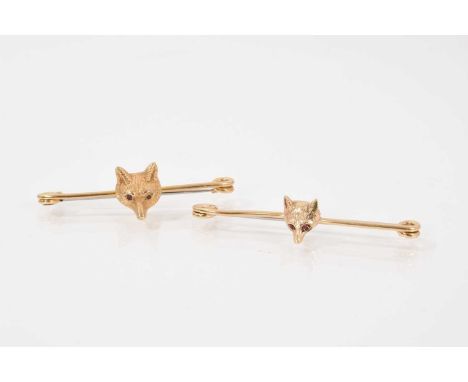 Two yellow metal fox mask bar brooches both set with ruby eyes, 5cm and 5.5cmBoth unmarked. Total weight 11.5 grams 