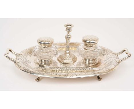 Victorian silver inkstand of two handled oval form with engraved decoration, fitted with a pair of silver mounted cut glass i