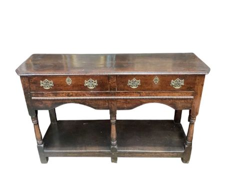 George III oak dresser base, enclosed by two drawers, on turned supports with pot shelf below