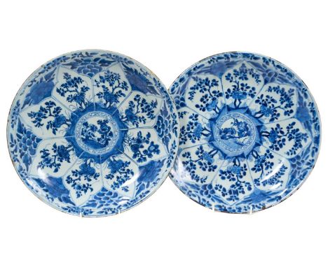 Pair of Chinese Kangxi period blue and white porcelain chargers, with segmented floral decoration, marked to bases, 35cm diam