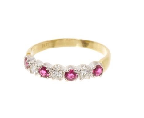 Ruby and diamond eternity ring with four round mixed cut rubies and three brilliant cut diamonds in claw setting on 18ct gold