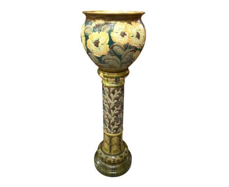 Burmantofts faience jardinière and stand, with tube-lined flowers in yellow, green and brown, impressed marks, the stand 89cm