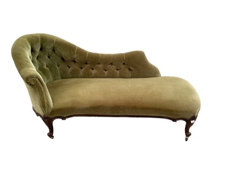 Victorian mahogany framed chaise longue, with moss green velvet button upholstery on shell carved show wood frame and castors
