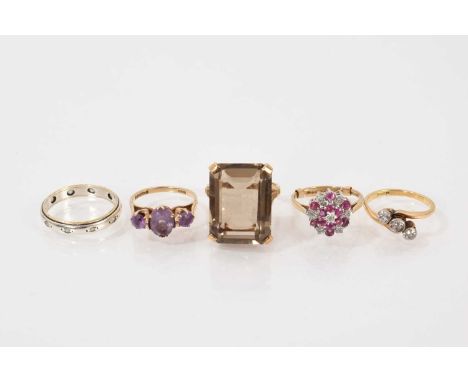 Group of five gold rings to include an antique diamond three-stone crossover ring in 28ct gold setting, ruby and diamond clus