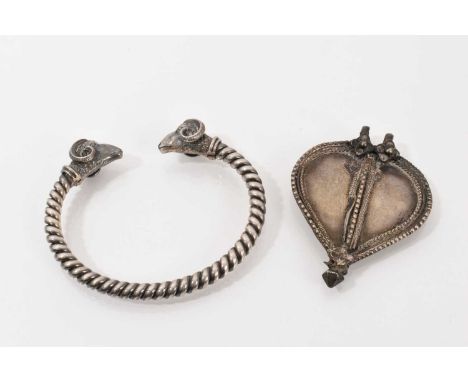 White metal rope twist torque bangle with ram's head terminals, together with an Eastern white metal leaf/heart shaped pendan
