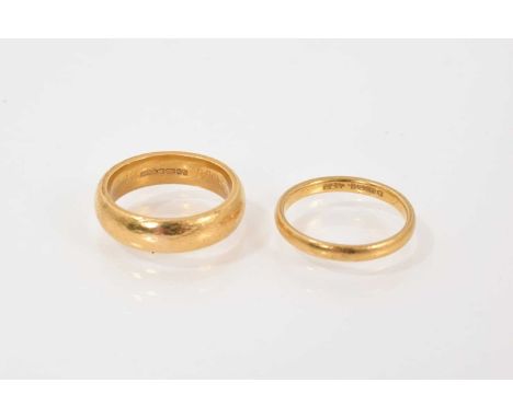 Two 22ct gold wedding bands to include a thin band (London 1952) and a thicker band (Birmingham 1991), both size KTotal weigh