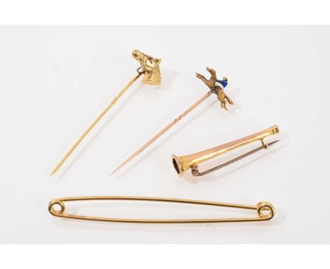 Group of hunting pins to include 9ct gold horse head stick pin set with ruby eyes, yellow metal and enamel jockey on race hor