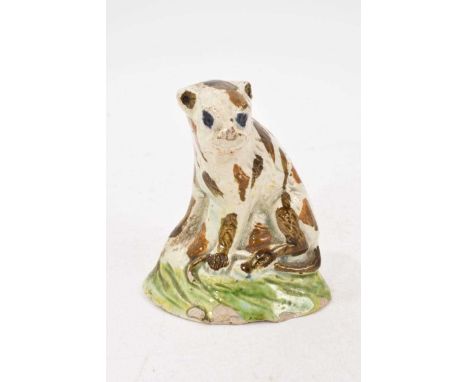 Prattware model of a wild animal, circa 1810, with brown streaked fur and blue eyes, on a green base, 7cm highChips to the ba