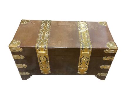 Oriental brass bound teak trunk, with flanking brass handles, 93cm wide x 45cm deep x 47cm high. Label inside for Keen Hing. 
