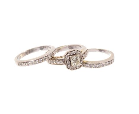 Diamond cluster ring and pair of half eternity rings, the cluster with a central radiant cut diamond, estimated to weigh appr