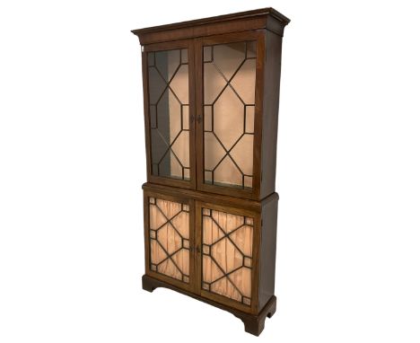 19th century mahogany bookcase on cabinet, projecting moulded cornice over four astragal glazed doors, the lower doors with l