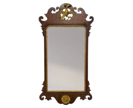 19th century mahogany Chippendale design fretwork wall mirror, the pediment carved and pierced with hoho bird, bevelled mirro